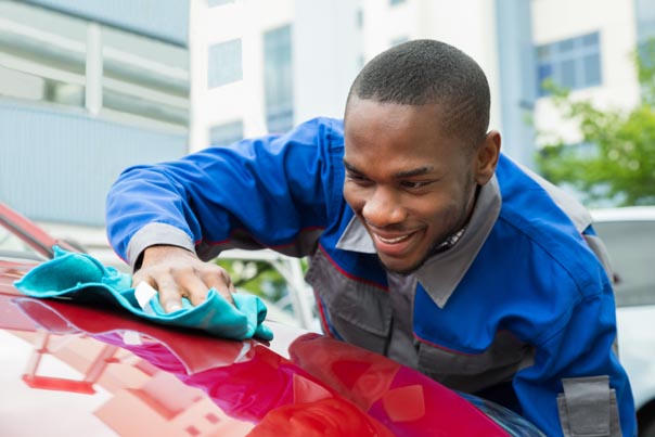 Male Worker Detailing Car